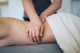 Client receiving deep tissue massage for lumbar pain