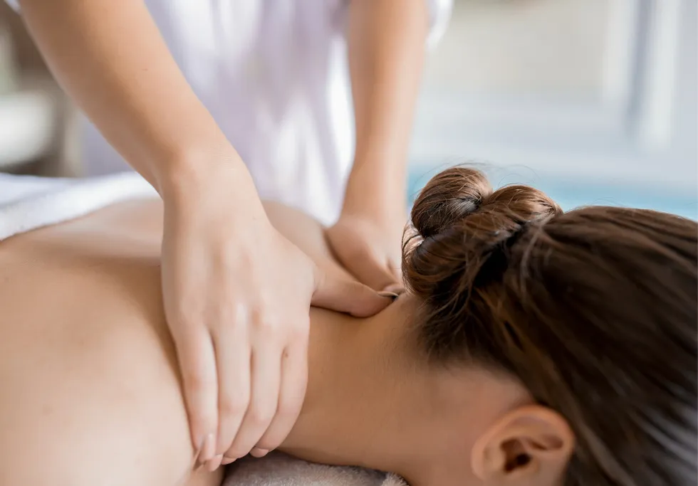Massage therapist treating neck stiffness at K Spa Bellevue