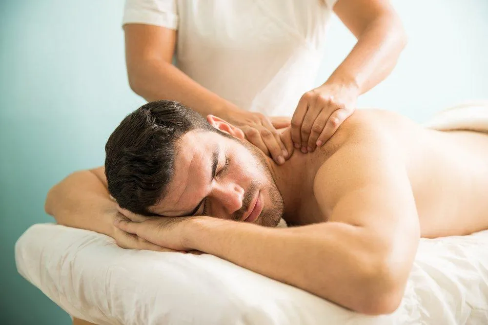 Client with limited neck movement receiving gentle massage