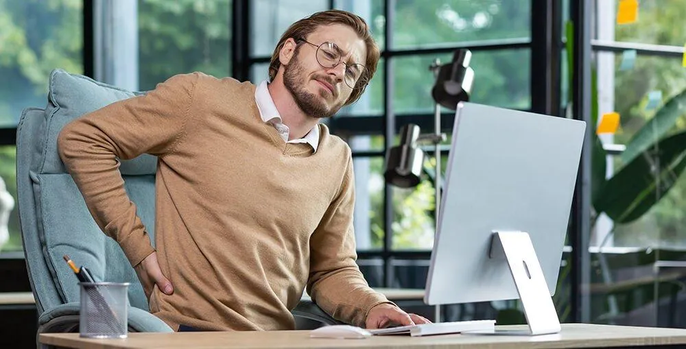 Office worker receiving back massage for posture correction