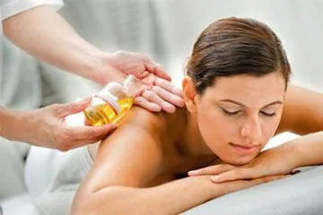 Client enjoying calming essential oil massage session