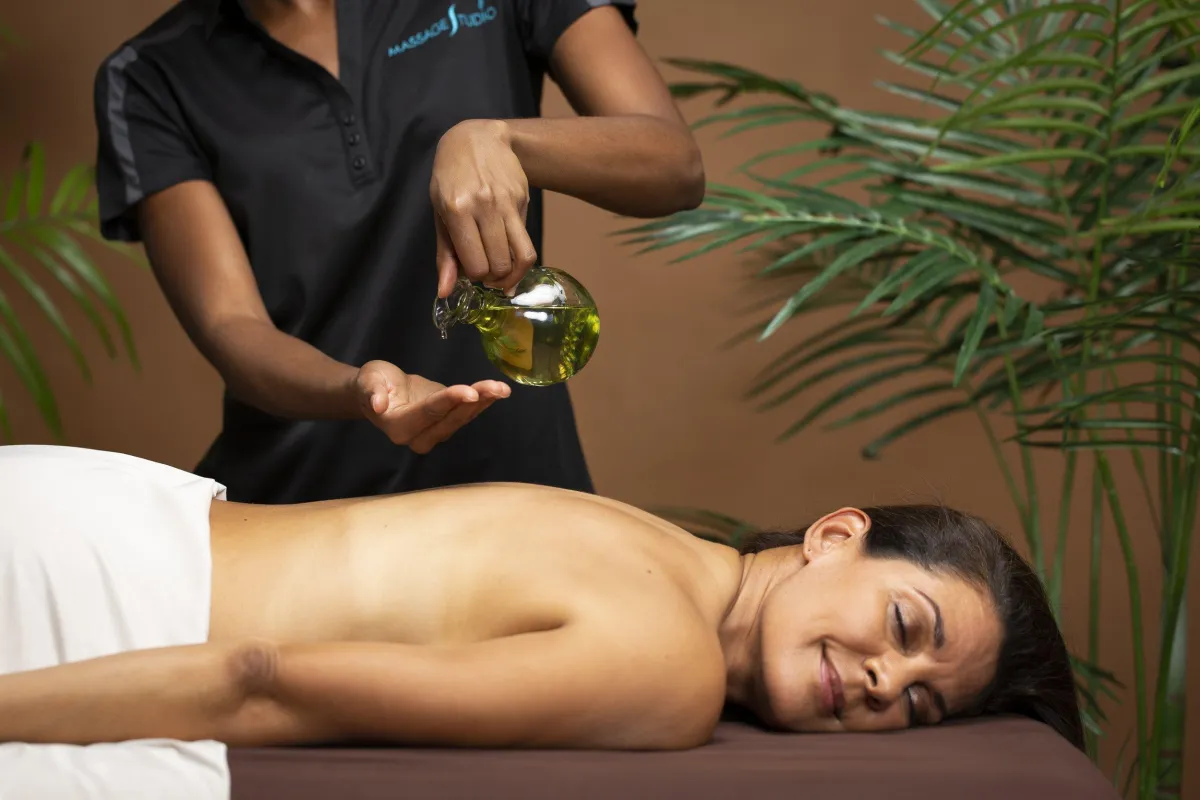Client receiving CBD-infused massage for pain relief