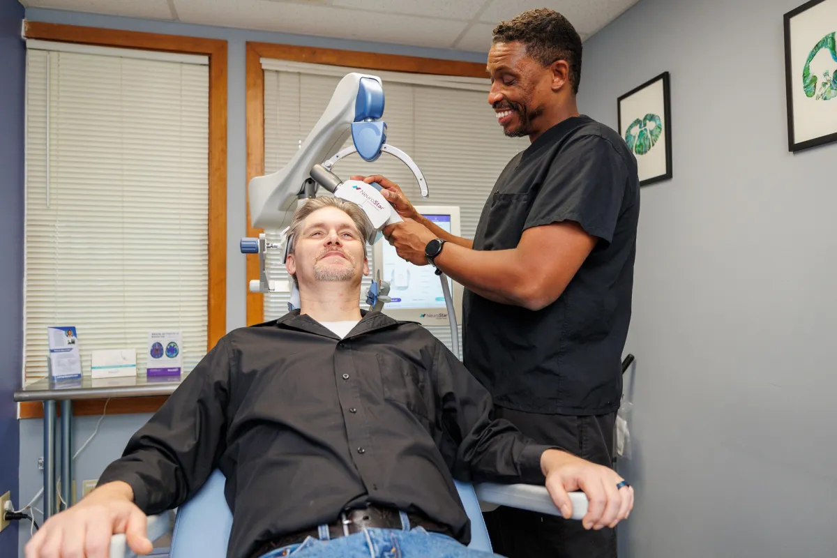 Dr. Landrum placing TS coil on patient's head 