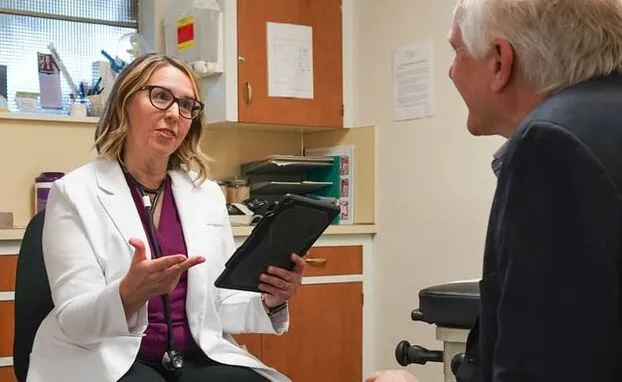 Dr. Hamill with patient in consultation room