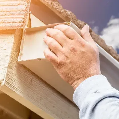 Image of Roofer inspecting roof for damage.