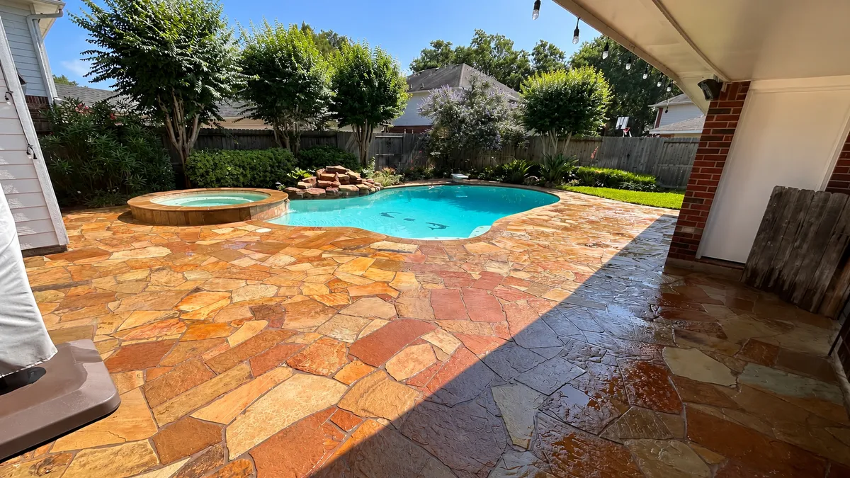 Clean stone pool deck and patio after exterior pressure washing