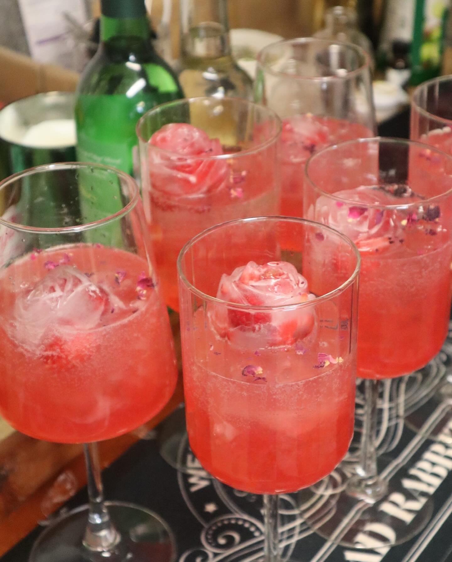 Freshly made pink cocktails lined up for guests at a Denver cocktail catering event with mobile bar service