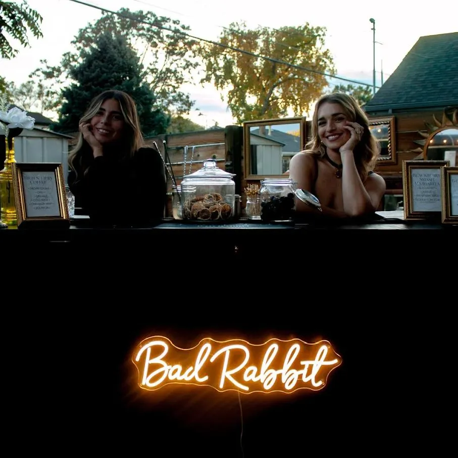 Bad Rabbit Caravan coffee catering in Denver with mobile bar service setup and smiling baristas at an outdoor event
