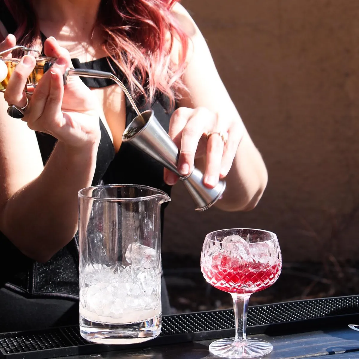 Professional mobile bar and coffee catering Denver with bartender preparing a cocktail with fresh ingredients and ice