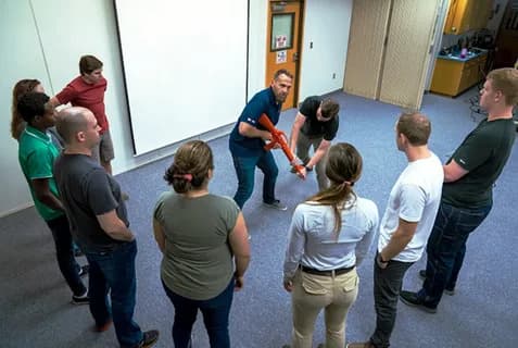 Group safety training session demonstrating emergency response techniques in workplace