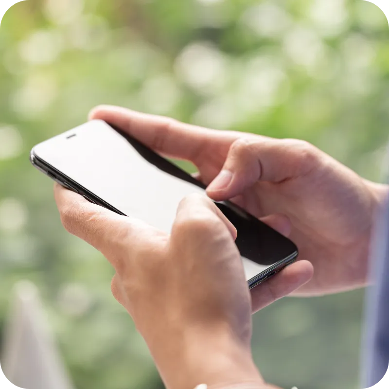 Person holding and using a smartphone.