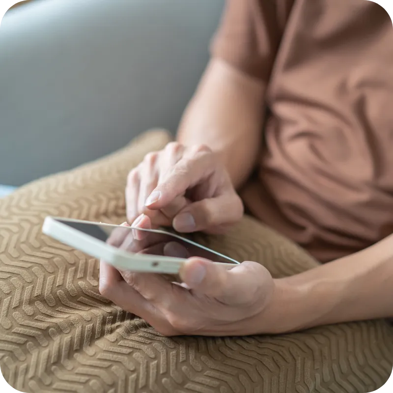 Person holding a smartphone and sending a text message.