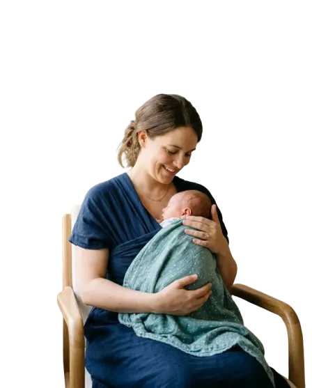 Calm lifestyle portrait of a mother holding her newborn baby in soft, natural morning light
