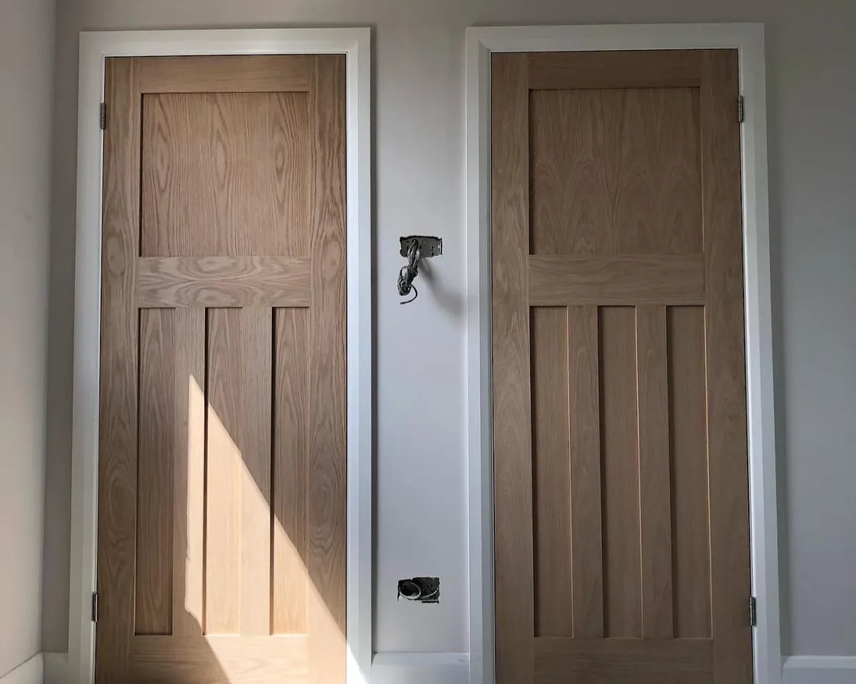 Door fitting in Hove with an internal oak door being hung on a level frame