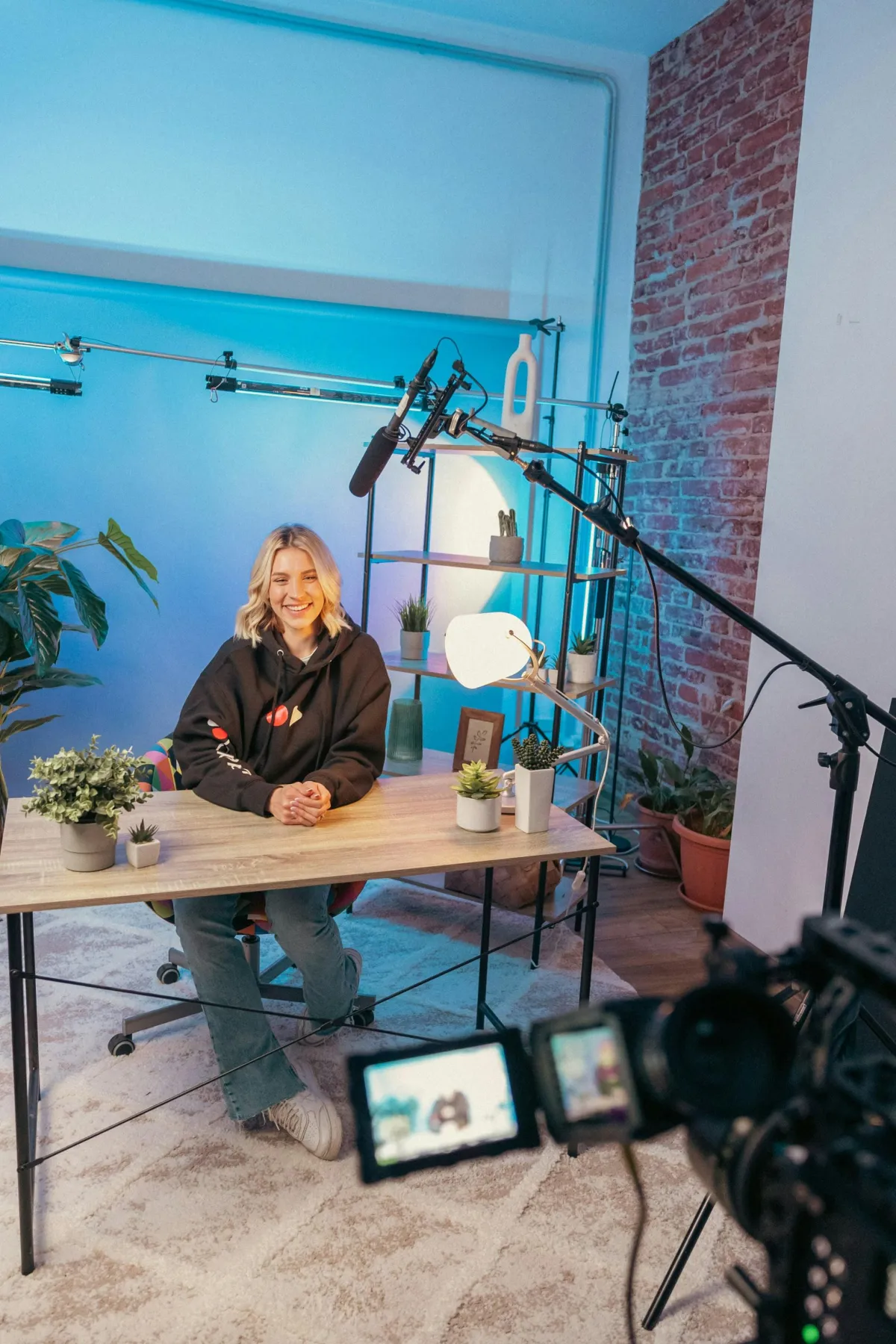 Editorial portrait of an established digital creator in a minimalist architectural workspace