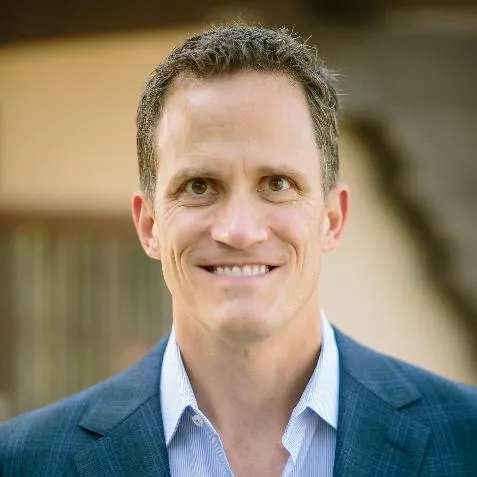 a couple of people sitting on top of a rock