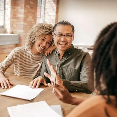 happy couple smiling because they got their dream home