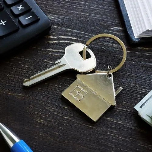 keys for their house on a black table 