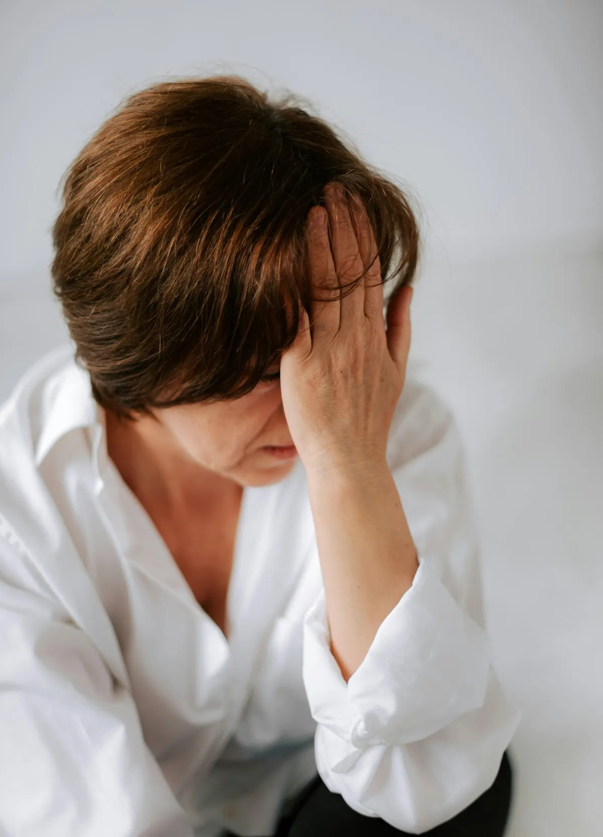 Woman holding her head in pain