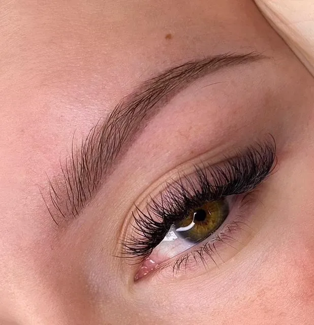 A woman with red hair looks directly into the camera.