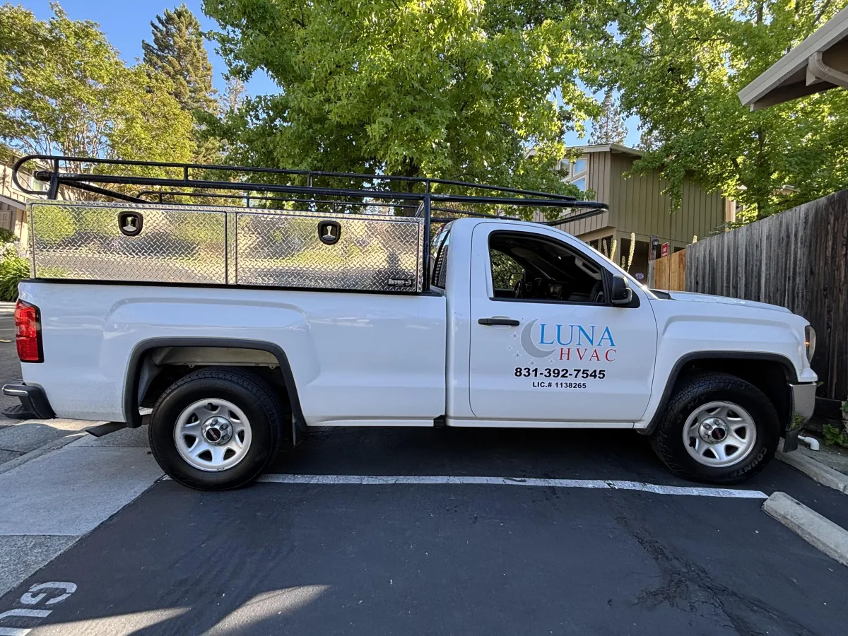 Certified Luna HVAC technician performing a residential AC system diagnostic and maintenance check in Marina, CA.