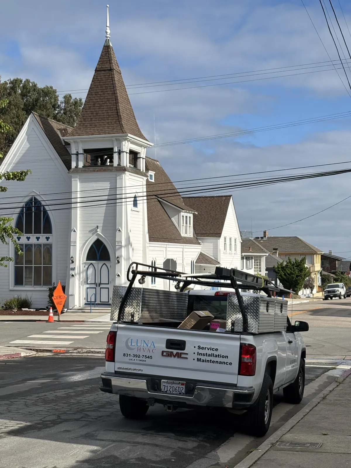Certified Luna HVAC technician performing a residential AC system diagnostic and maintenance check in Marina, CA.