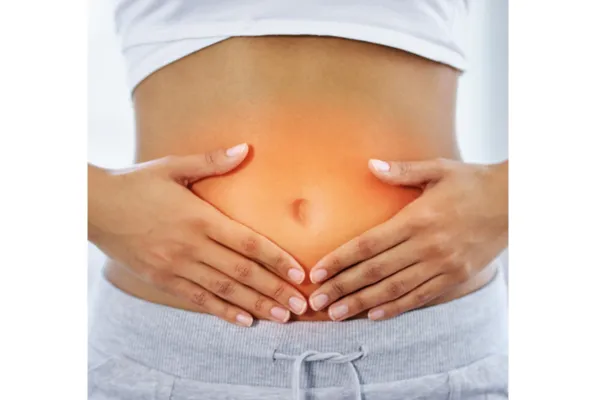Hands holding stomach representing gut health and digestive healing.
