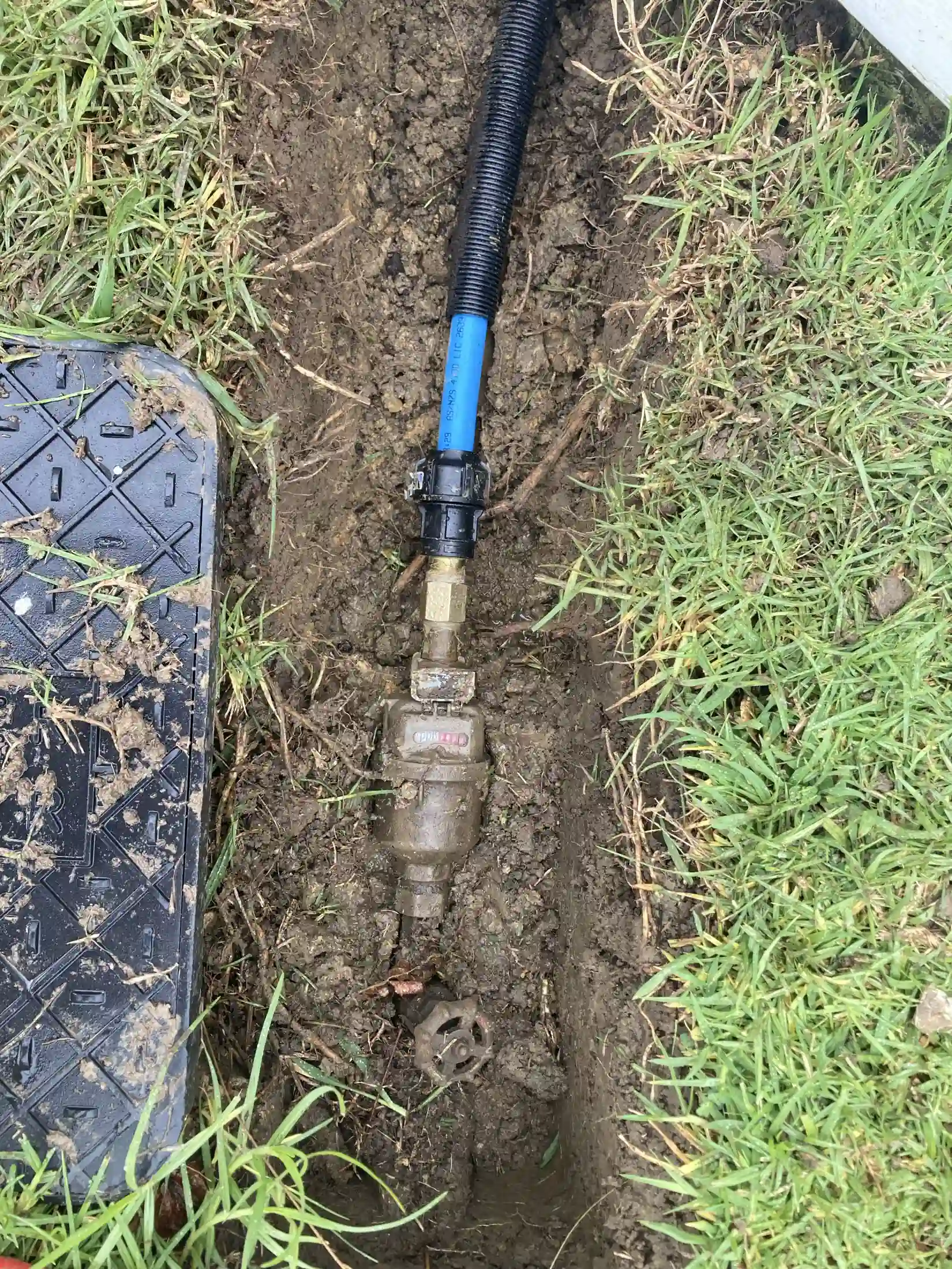 Plumber working on Water Main Repairs in a Birkdale home