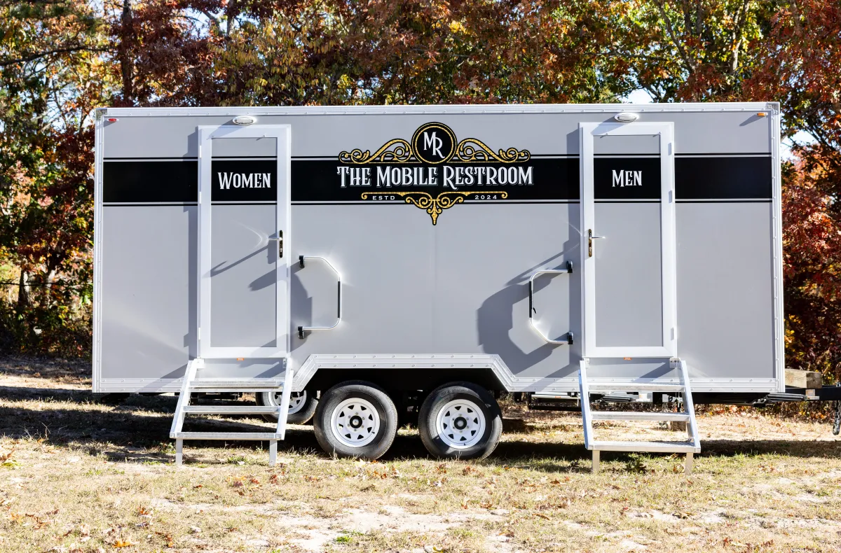 man in black and orange jacket under blue sky