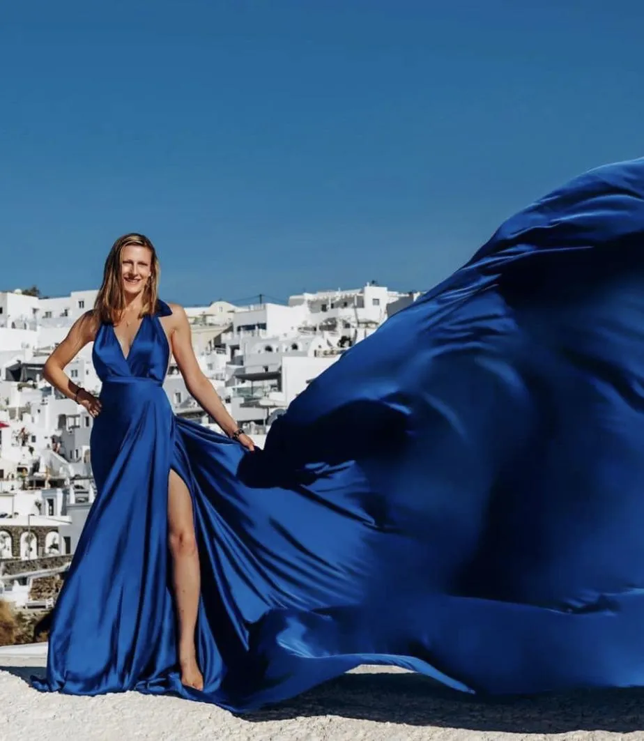Jennifer Licciardi wearing a stunning blue satin dress with a flowing train.