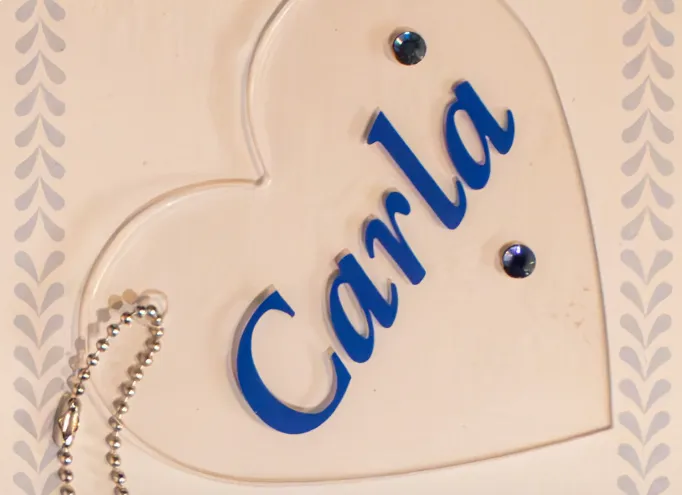 Clear acrylic keychain with 'Carla' in blue script and a decorative bead