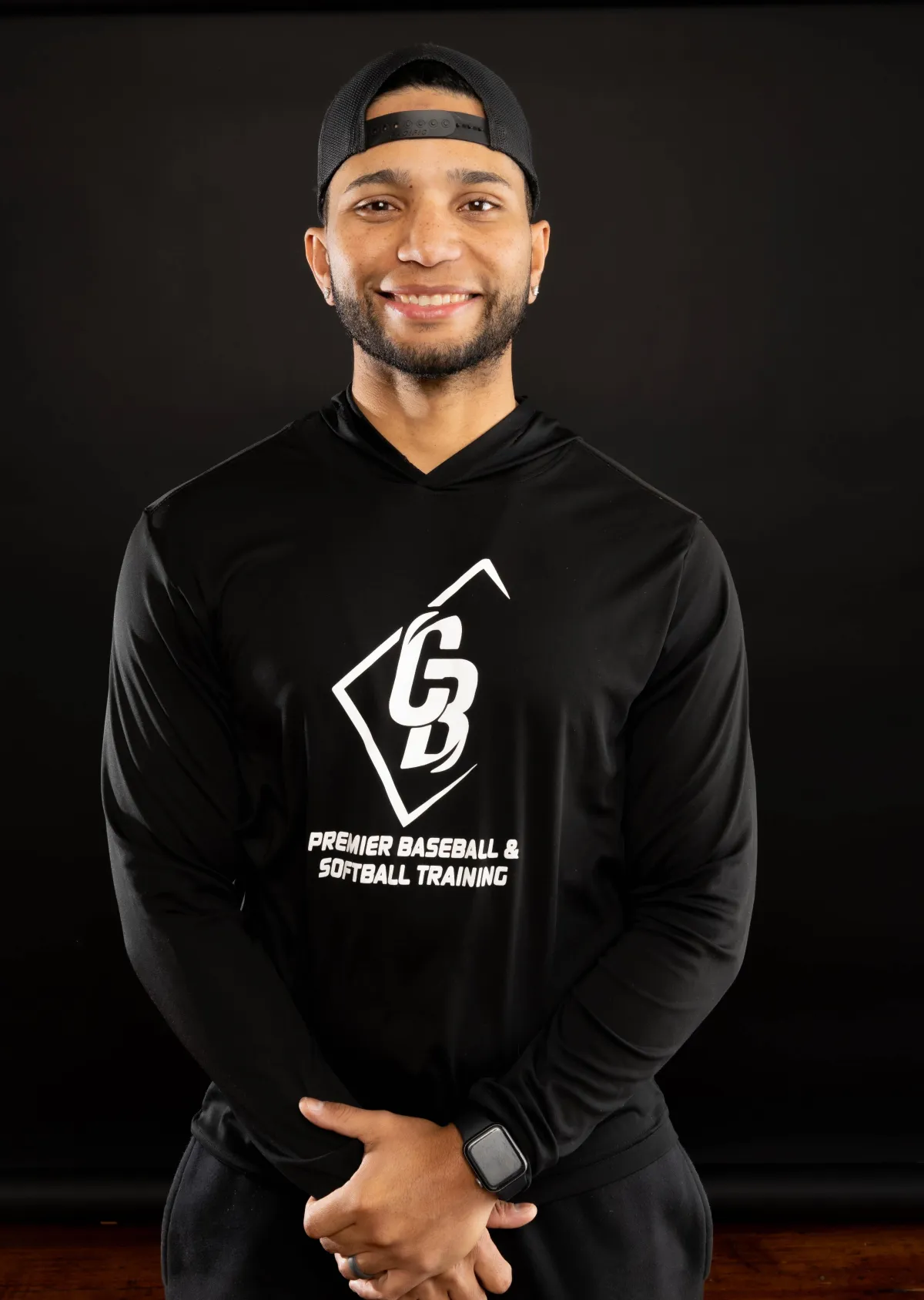 High school baseball player working with a coach in batting cage