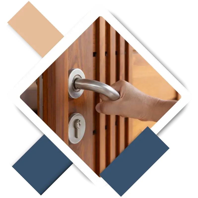 Hand gripping a modern door handle on a wooden door, illustrating professional door installation services in The Woodlands, TX, enhancing security and aesthetic appeal.