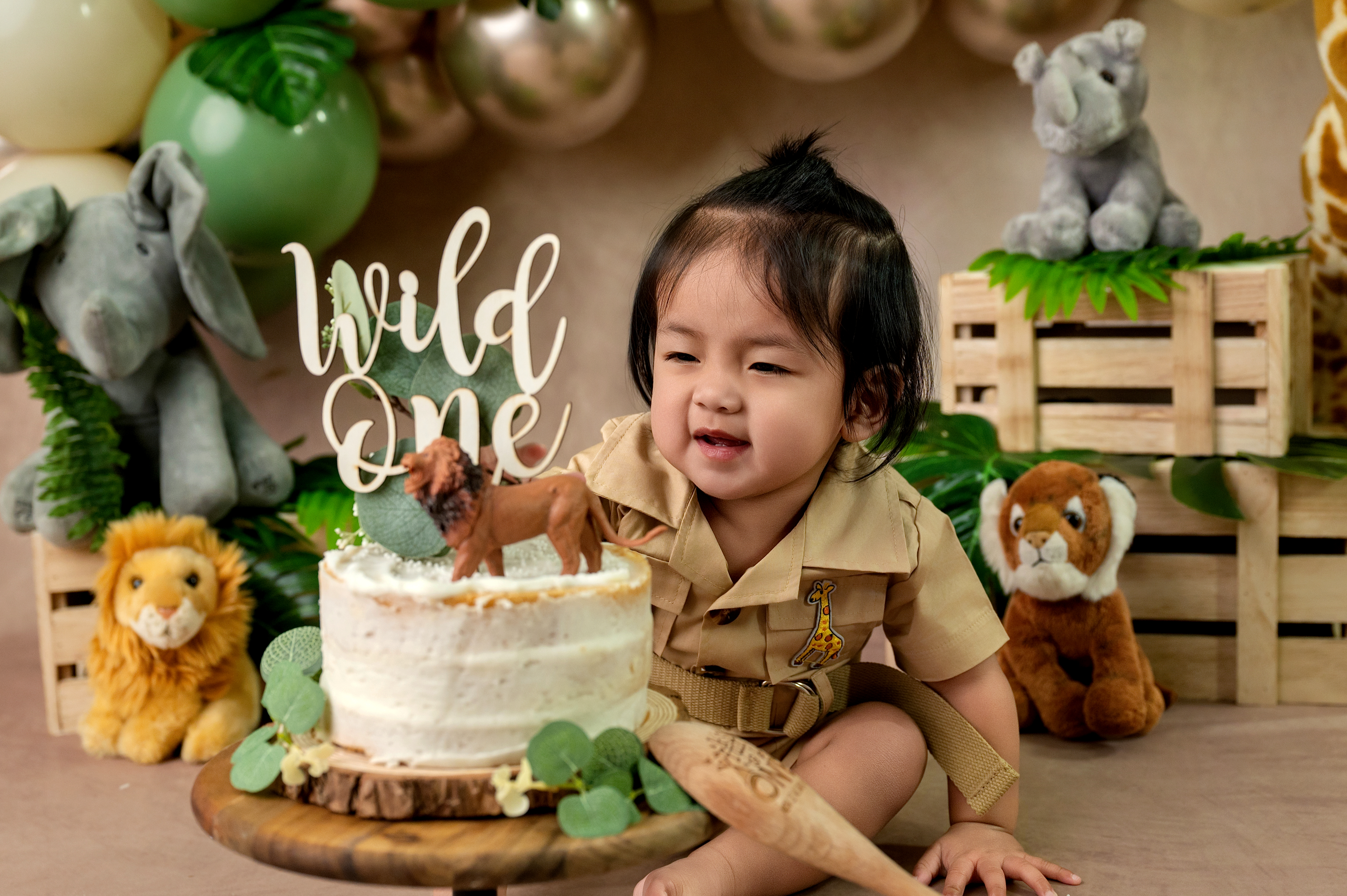 Joyful one year old baby with a beautiful birthday cake