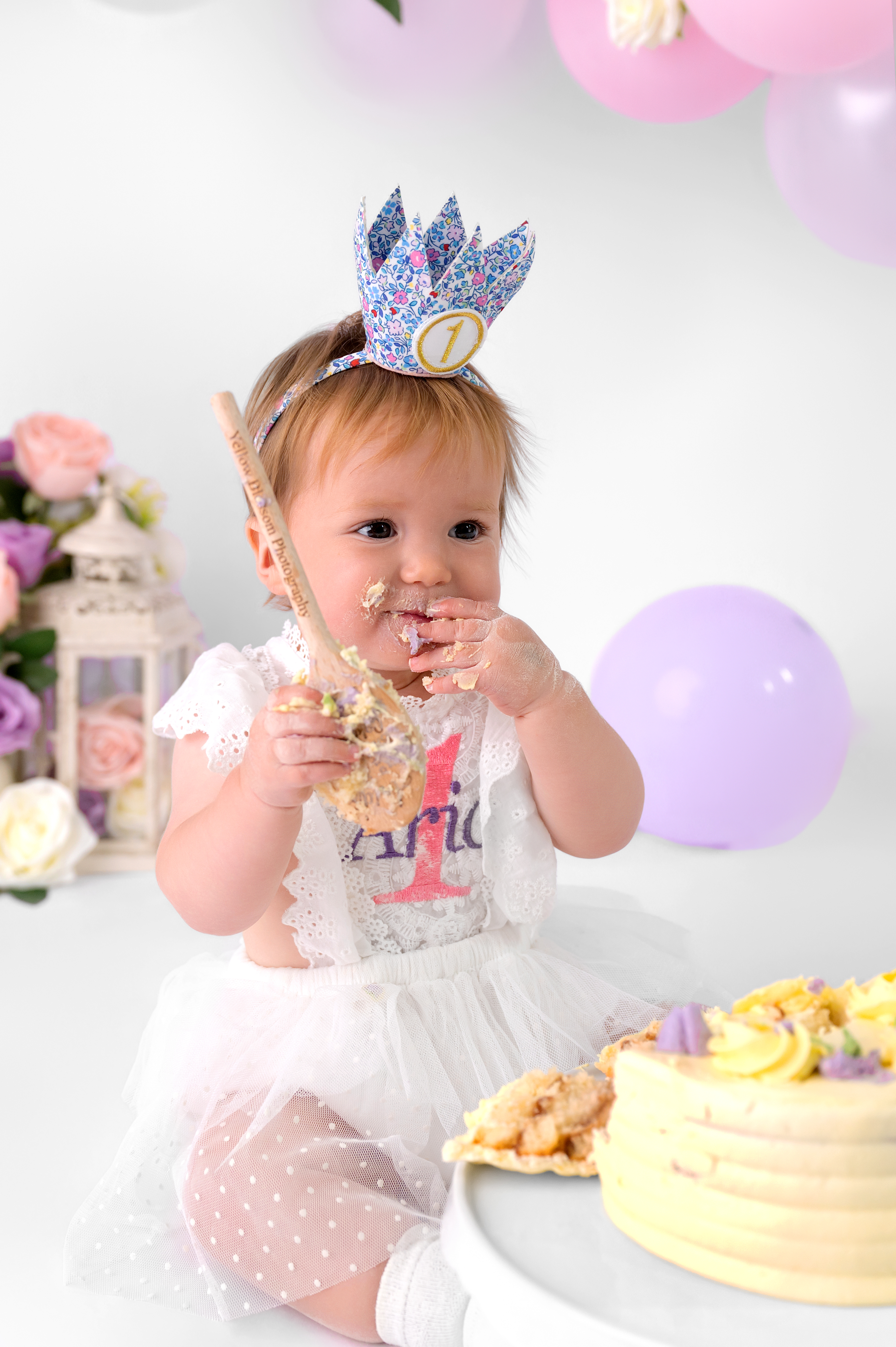 A sophisticated one-year-old birthday portrait featuring a simple neutral cake, embodying elegant and timeless photography.