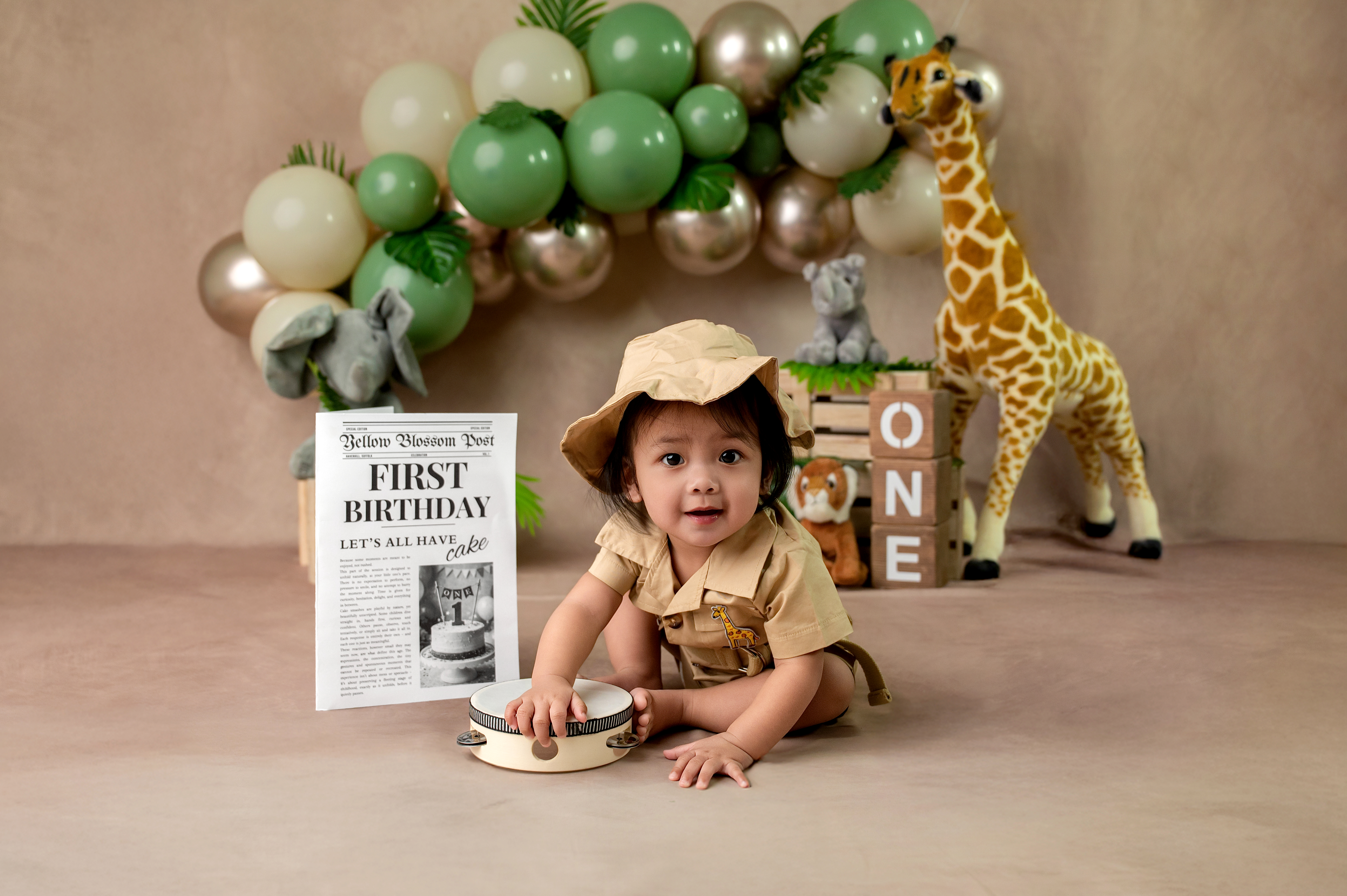 Joyful one year old baby with a beautiful birthday cake