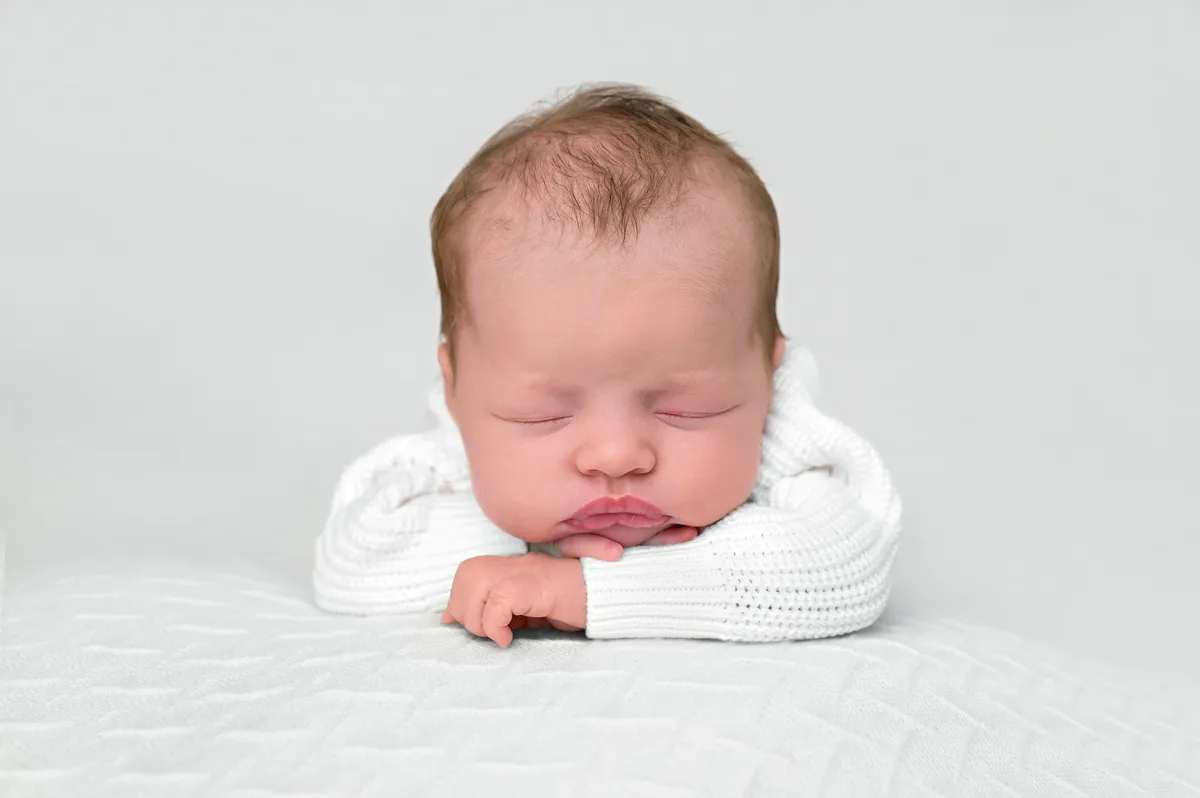 Customer portrait of Charlotte holding her newborn baby Isla
