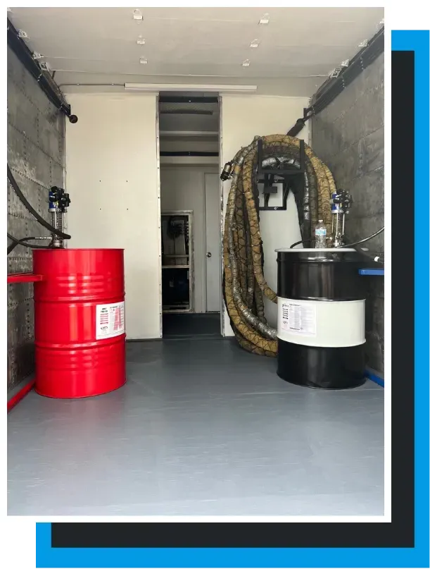 Refurbished spray foam rig with chemical drums and hose setup by Spray Tech Services in Panama City, FL