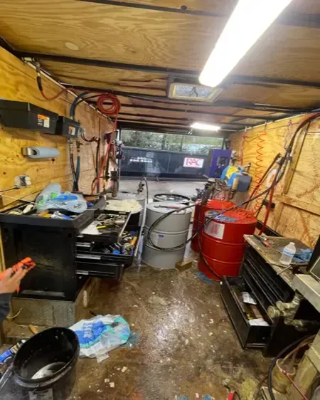 Used spray foam rig interior with chemical drums, hoses, and tools shown before refurbishment by Spray Tech Services, Panama City FL