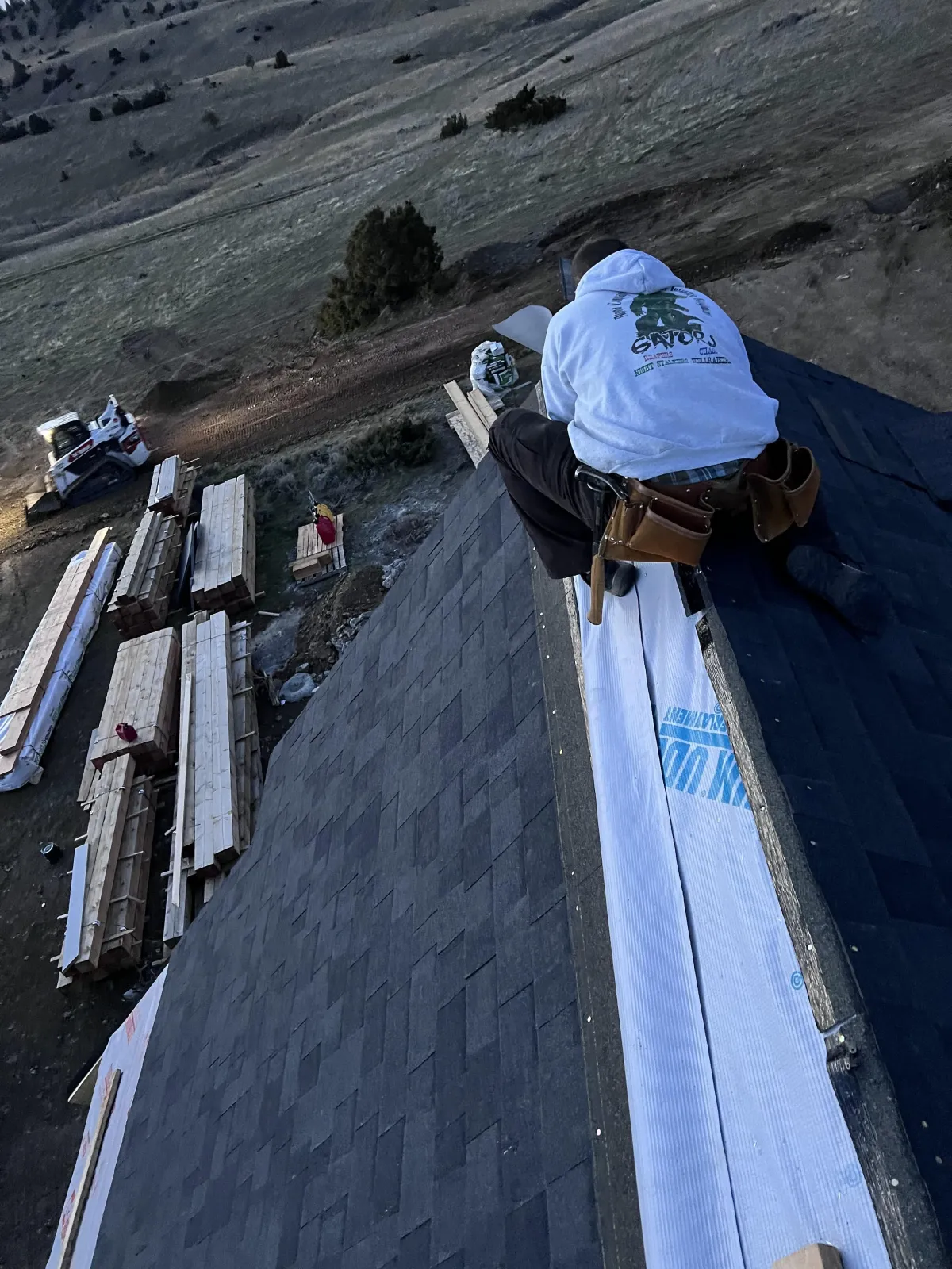 Completed asphalt re-roof on a 1970s bungalow in downtown Livingston with new dark shingles and crisp ridge lines.