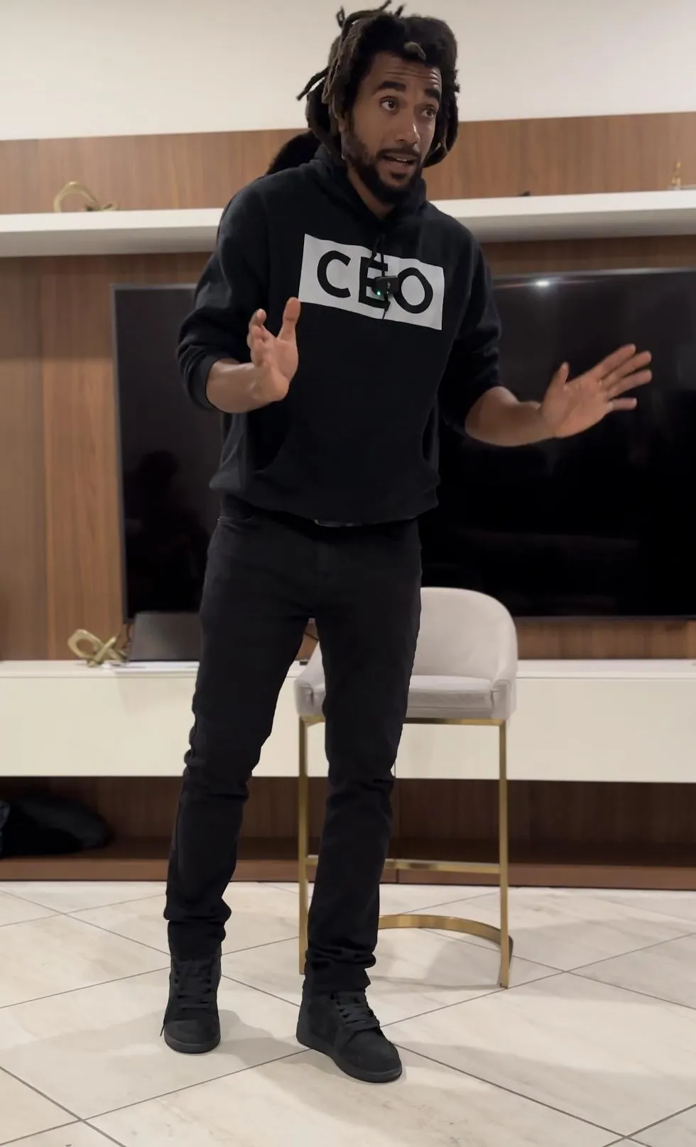 man standing beside another sitting man using computer