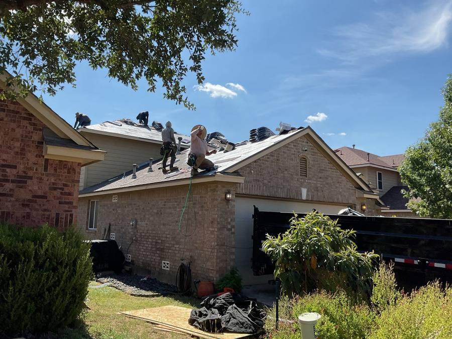 Roofs By Ty crew installing new shingles on residential roof