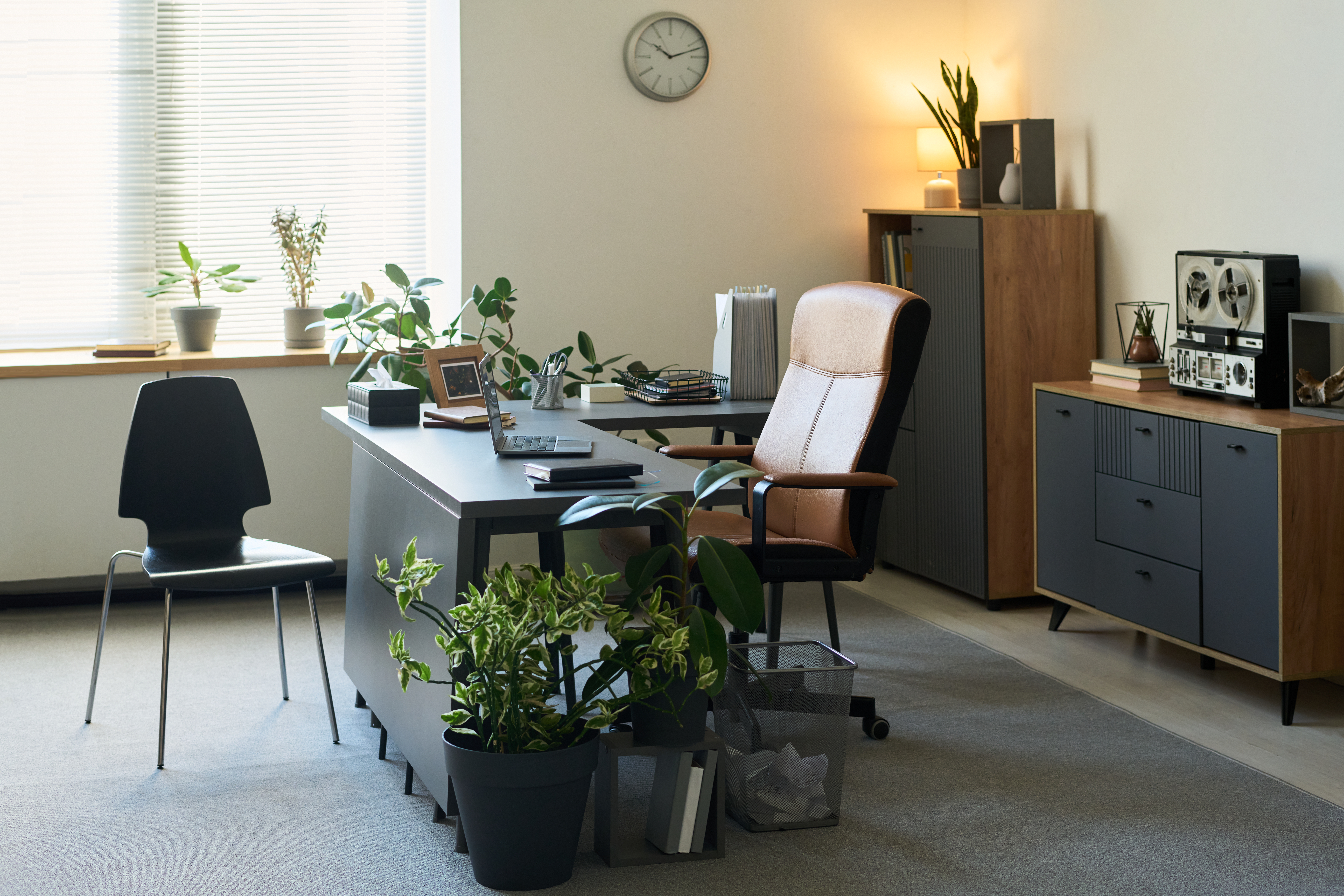 Hand holding a white and black spray bottle.