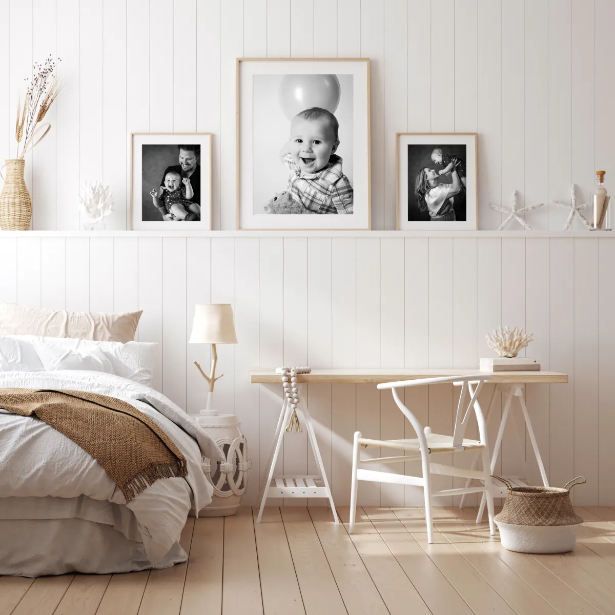 Framed newborn and sibling portraits displayed as wall art in a cozy nursery with crib, desk, and soft neutral decor. Artwork by Yucaipa newborn photographer Kendra Greenberg Photography