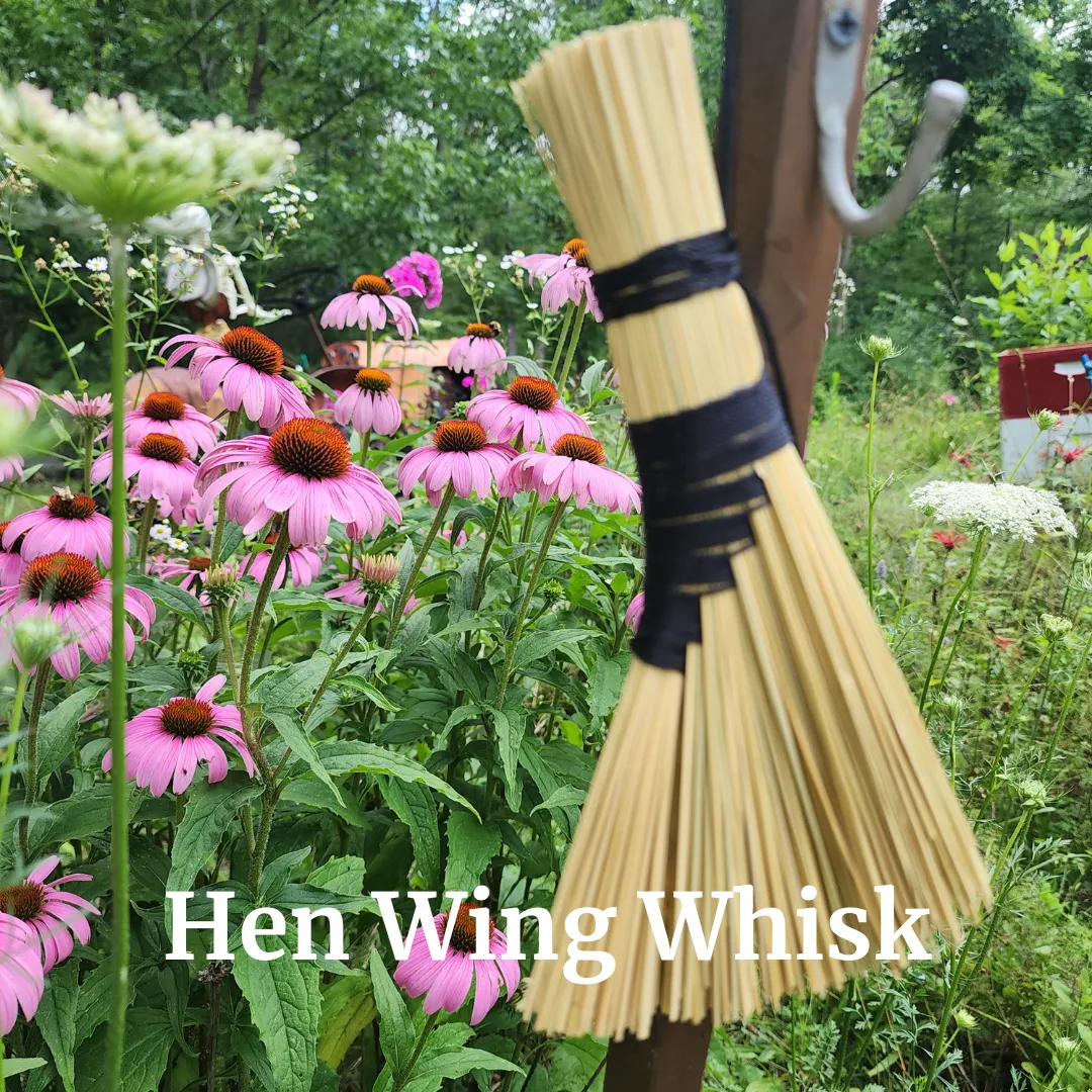 person holding brown stick on green grass field during daytime