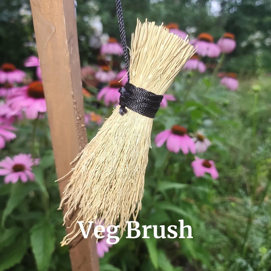 a bird sitting on top of a straw covered umbrella