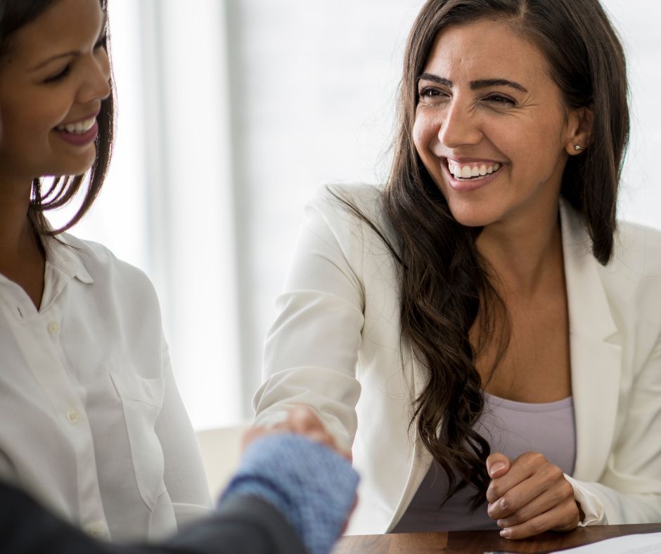 Med spa client shaking hands with an unknown provider at the front desk while an esthetician looks on in the background, representing patients quietly choosing a competitor.