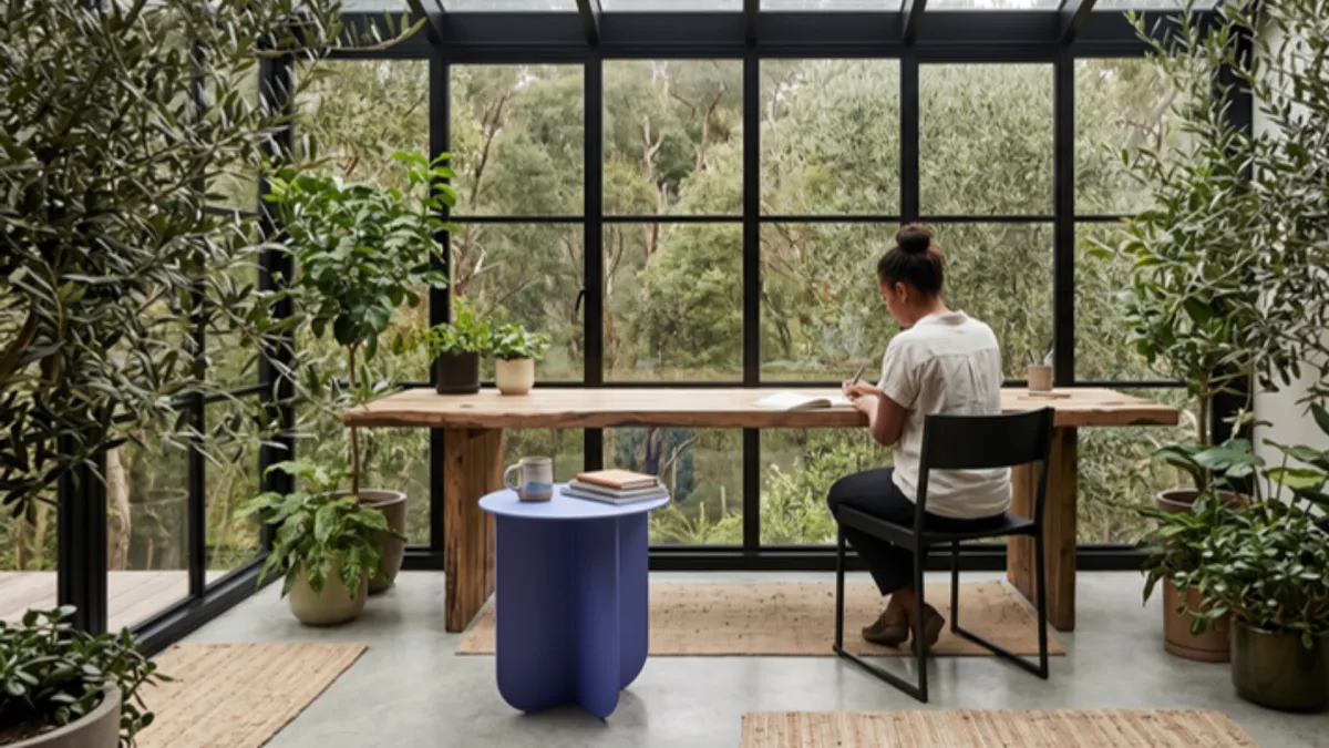 Woman working in office with many plants