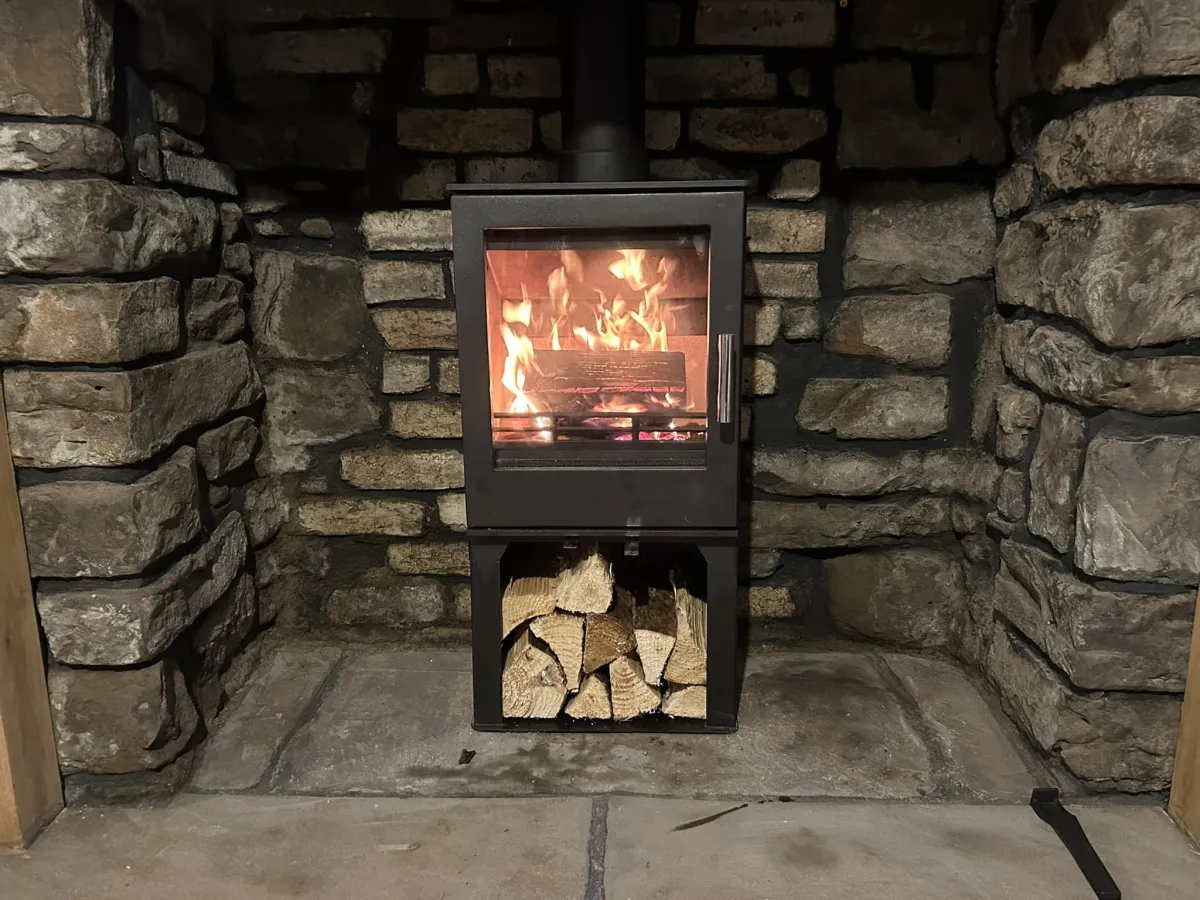 lighted candle beside brown wooden drawer