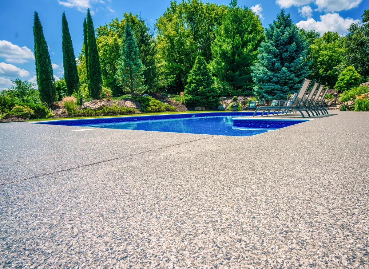 beautiful pool deck with landscaping